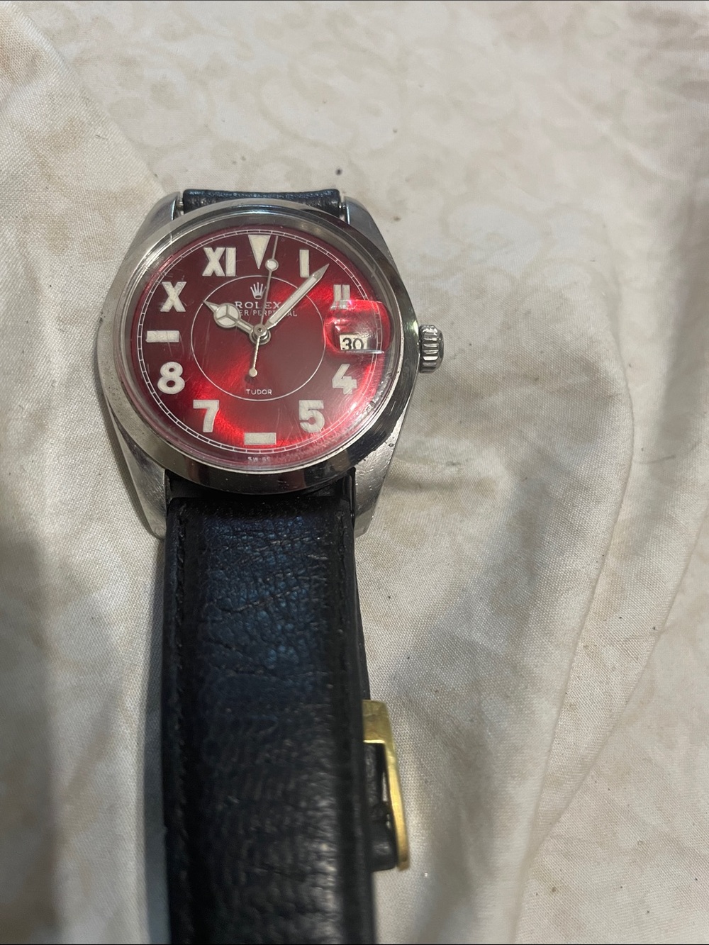 Rolex  Red Dial Watch with Black Strap and Gold Buckle